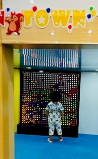 Child playing at the interactive light wall at Kids Fun Town